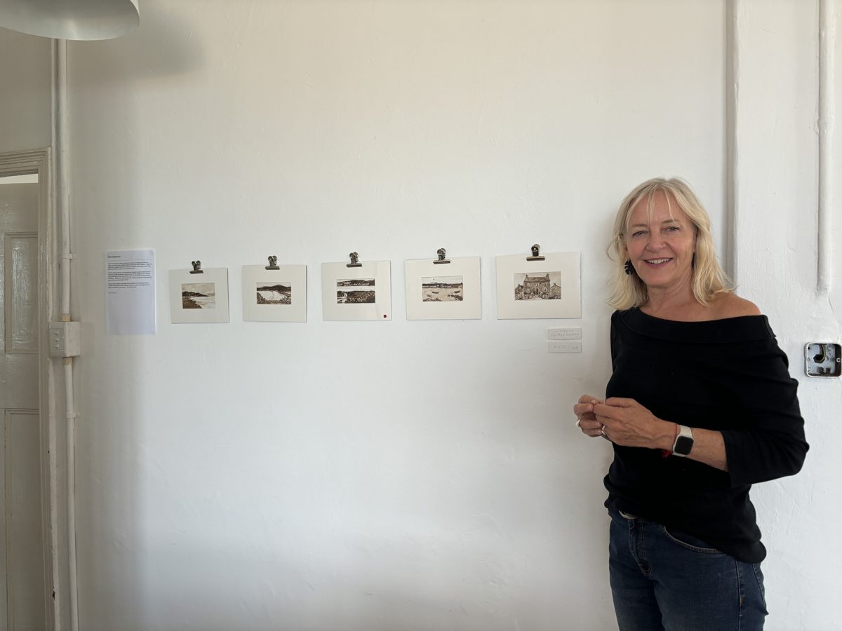 Kay standing beside her artwork at an exhibition